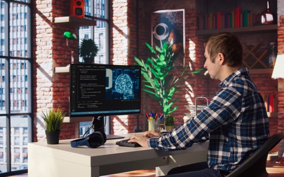 Engineer working at a computer running AI tooling